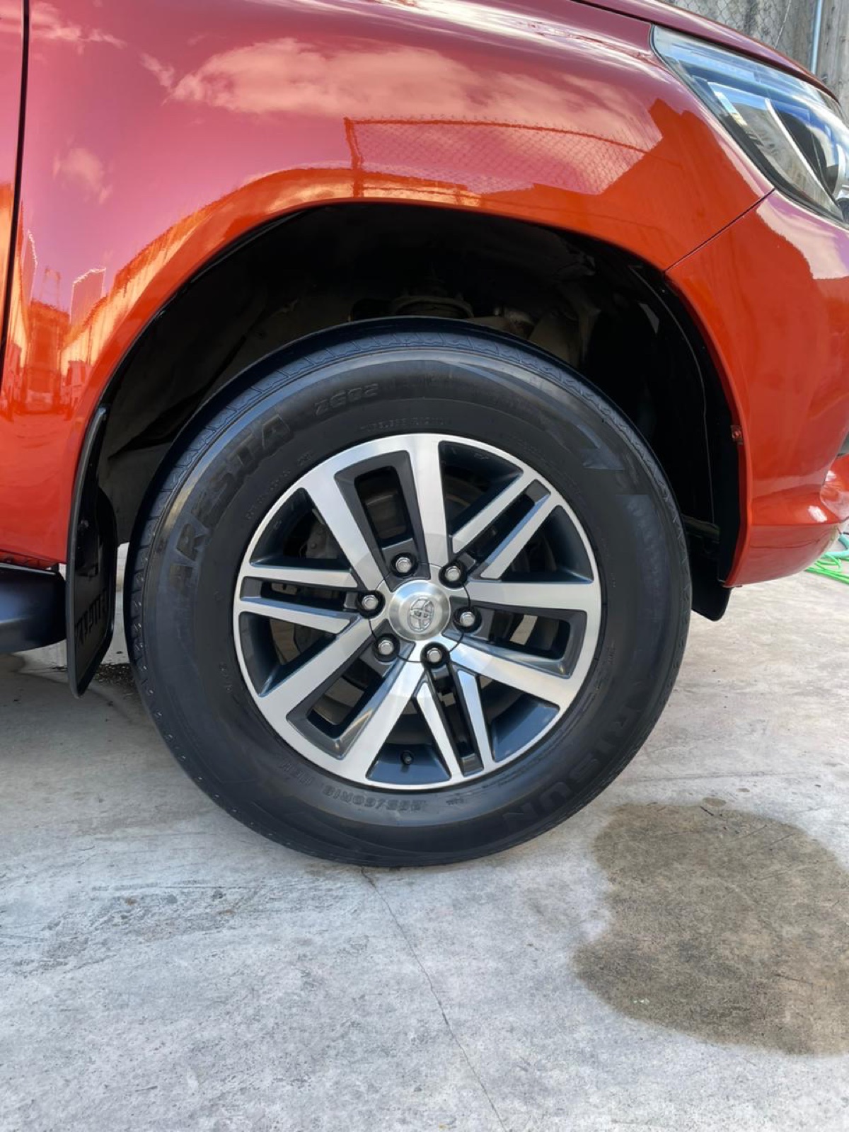 Washed wheel and shined tire after an exterior detail